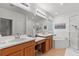 Bright bathroom with double sink vanity, soaking tub and glass enclosed shower at 33975 Astoria Cir, Wesley Chapel, FL 33545