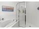 Close up view of the bathroom featuring a soaking tub and glass-enclosed shower at 33975 Astoria Cir, Wesley Chapel, FL 33545