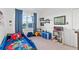Bedroom with a bed that has an avengers theme, blue accents and a window at 33975 Astoria Cir, Wesley Chapel, FL 33545