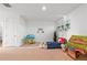 Bright bonus room with plush carpet and natural light from the hanging plants near the windows at 33975 Astoria Cir, Wesley Chapel, FL 33545
