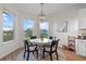 Charming breakfast nook with bright light fixture and views of the water at 33975 Astoria Cir, Wesley Chapel, FL 33545
