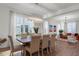 Elegant dining room featuring wood floors, a modern chandelier, and large windows at 33975 Astoria Cir, Wesley Chapel, FL 33545