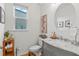 Stylish half bathroom with gray vanity, marble countertop, and modern fixtures at 33975 Astoria Cir, Wesley Chapel, FL 33545