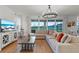 Bright living room boasts modern decor, a large TV, and sliding glass doors to the backyard at 33975 Astoria Cir, Wesley Chapel, FL 33545
