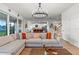 Cozy living room with large sectional sofa, modern lighting, and an open floor plan at 33975 Astoria Cir, Wesley Chapel, FL 33545