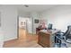 Home office featuring wood floors, a large desk, and ample storage space at 33975 Astoria Cir, Wesley Chapel, FL 33545
