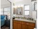 Bright bathroom with wood vanity, ample counter space, and a view into the Primary bedroom at 7075 Lafayette N, Pinellas Park, FL 33781