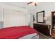 Bright bedroom featuring a red bedspread, wardrobe, closet and wood floors at 7075 Lafayette N, Pinellas Park, FL 33781
