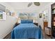 Serene bedroom with a large window, soft blue bedding, and ensuite bathroom access at 7075 Lafayette N, Pinellas Park, FL 33781