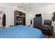 Bright bedroom with a blue comforter, dresser, and relaxing chair at 7075 Lafayette N, Pinellas Park, FL 33781