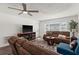 Living room with brown sofas, a TV, and wood-look floors at 7075 Lafayette N, Pinellas Park, FL 33781