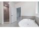 Primary bath with modern tub, tiled shower, and tile flooring at 804 W Peninsular St, Tampa, FL 33603