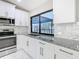 White kitchen with granite counters, stainless steel appliances and a window at 8139 Wooden Dr, Spring Hill, FL 34606