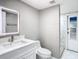 Modern bathroom with white vanity, marble floors and walk-in shower at 8139 Wooden Dr, Spring Hill, FL 34606