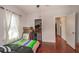 Bedroom with striped bedspread, closet, and hardwood floors at 8903 N Edison Ave, Tampa, FL 33604