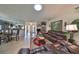 Spacious living room with leather furniture and a view into the kitchen at 909 Sun Key Ct, Sun City Center, FL 33573