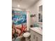 Clean bathroom with shower/tub combo and beach-themed decor at 919 50Th W Ave, Bradenton, FL 34207