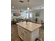 Kitchen island with white cabinets and a view into the living room at 919 50Th W Ave, Bradenton, FL 34207