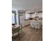 Kitchen boasts white cabinets, an island with seating, and wood-look flooring at 919 50Th W Ave, Bradenton, FL 34207