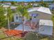 Mobile home with a patio, shed, and palm trees at 118 Saint Pierres Way, Apollo Beach, FL 33572
