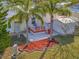 Elevated patio with a storage shed and tropical landscaping at 118 Saint Pierres Way, Apollo Beach, FL 33572
