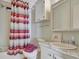 Bathroom with striped shower curtain, toilet, and a vanity with a granite countertop at 118 Saint Pierres Way, Apollo Beach, FL 33572