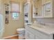 Clean bathroom with white vanity, a toilet, and a linen cabinet at 118 Saint Pierres Way, Apollo Beach, FL 33572