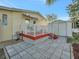 Spacious deck with red railings and patio furniture, overlooking a storage shed at 118 Saint Pierres Way, Apollo Beach, FL 33572