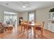 Charming dining area with wood table and chairs, hardwood floors, and access to living room at 118 Saint Pierres Way, Apollo Beach, FL 33572