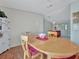 Well-lit dining area with hardwood floors, and a view of the kitchen at 118 Saint Pierres Way, Apollo Beach, FL 33572