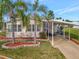 Single-wide manufactured home with carport, landscaping, and palm trees at 118 Saint Pierres Way, Apollo Beach, FL 33572