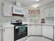 Clean and efficient kitchen with ample cabinetry and modern appliances at 118 Saint Pierres Way, Apollo Beach, FL 33572