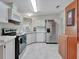 Kitchen with stainless steel appliances and wood cabinets at 118 Saint Pierres Way, Apollo Beach, FL 33572