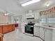 Kitchen with stainless steel appliances and wood cabinets at 118 Saint Pierres Way, Apollo Beach, FL 33572