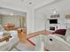 Open living room with hardwood floors, comfortable seating and a view to the dining area at 118 Saint Pierres Way, Apollo Beach, FL 33572