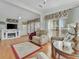 Relaxing living room showcasing comfortable seating, hardwood floors, and a fireplace at 118 Saint Pierres Way, Apollo Beach, FL 33572
