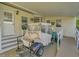 Covered porch with golf cart and access ramp at 118 Saint Pierres Way, Apollo Beach, FL 33572