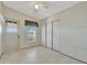 Room with sliding closet doors, window with blinds and exterior door access at 118 Saint Pierres Way, Apollo Beach, FL 33572