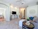 Living room with a gray sectional sofa, decorative wall art, and a view to the entryway at 1320 Misty Greens Dr, Sun City Center, FL 33573