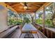 Screened porch with dining table and chairs, overlooking nature at 14740 Conway Rd, Port Charlotte, FL 33981