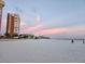 Scenic beach view with condo building and sunset at 17920 Gulf Blvd # 1508, Redington Shores, FL 33708