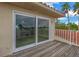 Private balcony with sliding glass doors and wooden deck, offering water views at 30 Dolphin Dr, Treasure Island, FL 33706