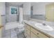Clean bathroom with a tub, toilet and vanity at 30 Dolphin Dr, Treasure Island, FL 33706