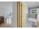 View of bathroom and bedroom with hardwood floors at 30 Dolphin Dr, Treasure Island, FL 33706