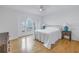 Bedroom with hardwood floors, large window and a queen-size bed at 30 Dolphin Dr, Treasure Island, FL 33706