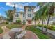 Mediterranean style home with a circular brick patio and mosaic table at 30 Dolphin Dr, Treasure Island, FL 33706
