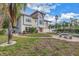 Mediterranean-style house exterior with a brick pathway and lush landscaping at 30 Dolphin Dr, Treasure Island, FL 33706