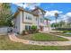 Two-story house with a Mediterranean style and a brick pathway at 30 Dolphin Dr, Treasure Island, FL 33706