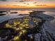 Stunning aerial view of the beachfront condominium complex at dusk with an ocean view and landscaped grounds at 800 Collany Rd # 605 & 606, Tierra Verde, FL 33715