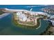 Aerial view of beachfront condos, surrounding water, and lush greenery for tropical living at 800 Collany Rd # 605 & 606, Tierra Verde, FL 33715